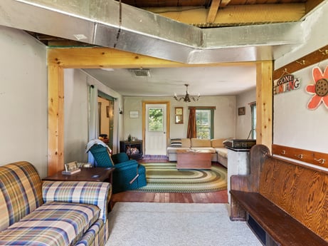 An image featuring property, furniture, building, comfort, interior design, houseplant, wood, floor, flooring, lamp at 1039 Old Bernice Rd.