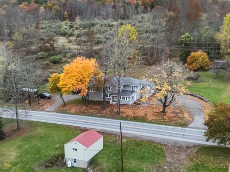 An image featuring plant, plant community, leaf, tree, window, land lot, biome, house, natural landscape, neighbourhood at 17899 US-6.
