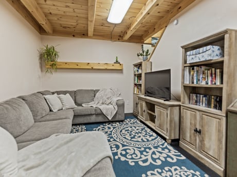 An image featuring picture frame, property, furniture, cabinetry, couch, interior design, wood, comfort, lighting, living room at 144 Milton Ln.