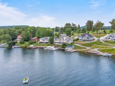 An image featuring water, sky, cloud, water resources, plant, building, boat, tree, lake, body of water at 218 Point Rd.