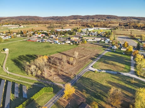 An image featuring plant, sky, water resources, natural landscape, land lot, urban design, tree, residential area, grass, thoroughfare at Elm Dr.