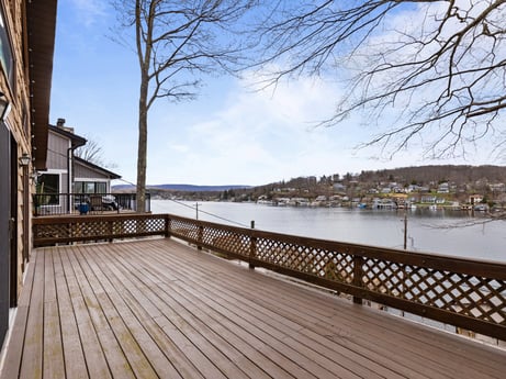 An image featuring water, sky, cloud, building, wood, fence, body of water, lake, tree, house at 815 Lakeside Dr.