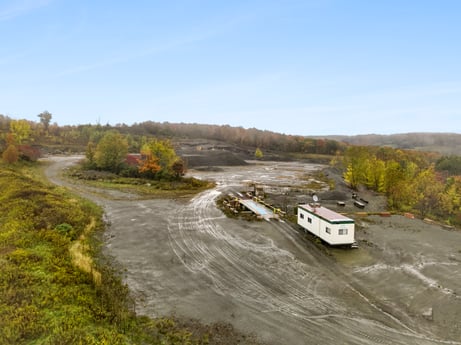 An image featuring sky, plant, asphalt, highland, cloud, watercourse, vehicle, tree, bank, natural landscape at Cheney Road.