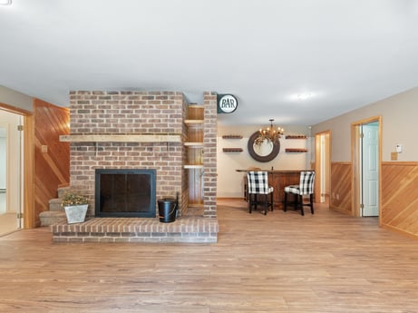 An image featuring building, table, door, wood, hall, living room, clock, flooring, hearth, wood stain at 276 Mountain View Ln.