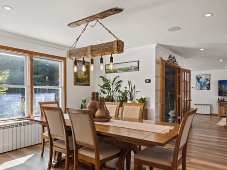 An image featuring table, plant, property, furniture, chair, wood, houseplant, interior design, floor, window at 125 Rimstone Ct.