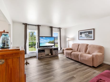 An image featuring comfort, cabinetry, wood, couch, flooring, floor, interior design, living room, houseplant, hardwood at 105 Thomas St.