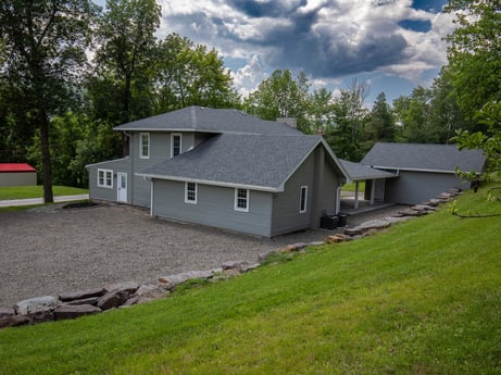An image featuring cloud, building, sky, window, plant, house, tree, land lot, siding, cottage at 17899 US-6.