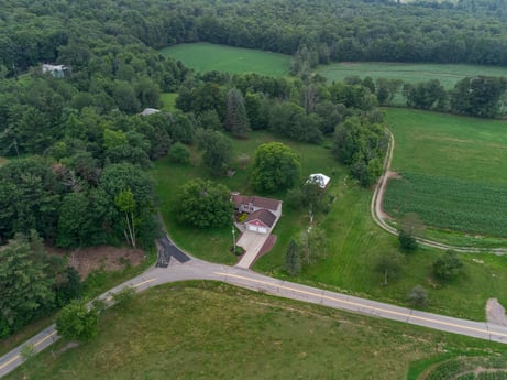 An image featuring plant, property, tree, natural landscape, slope, land lot, vegetation, urban design, thoroughfare, road surface at 3869 Sportsmans Rd.