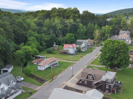 An image featuring sky, building, plant, tree, cloud, land lot, urban design, neighbourhood, residential area, house at 138 T-329.