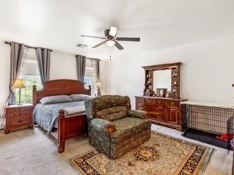 An image featuring furniture, property, picture frame, ceiling fan, window, wood, building, comfort, cabinetry, interior design at 105 Thomas St.