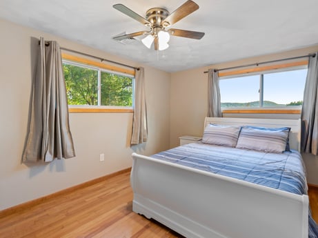 An image featuring furniture, ceiling fan, window, comfort, building, wood, shade, interior design, architecture, floor at 491 Hillcrest Dr.