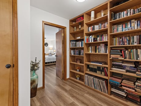 An image featuring furniture, property, shelf, bookcase, book, wood, shelving, interior design, publication, door at 125 Rimstone Ct.