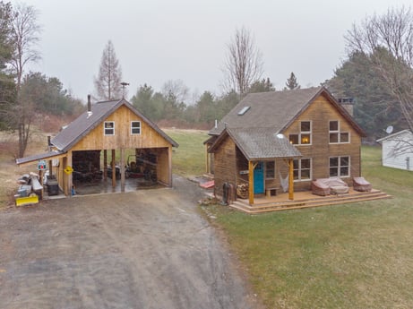 An image featuring sky, plant, window, tree, wood, building, house, land lot, siding, landscape at 144 Milton Ln.