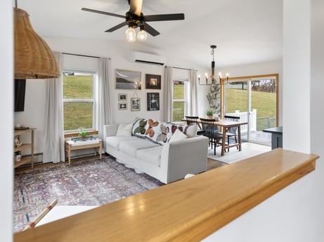 An image featuring table, furniture, picture frame, ceiling fan, couch, wood, interior design, living room, chair, flooring at 18 Country View Dr.