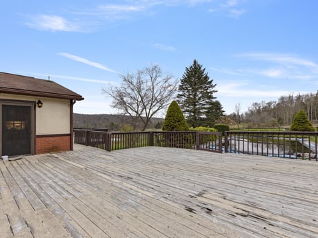 An image featuring cloud, sky, tree, wood, road surface, land lot, grass, building, cottage, fence at 1569 S Macafee Rd.