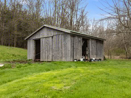 An image featuring plant, building, sky, tree, natural landscape, wood, land lot, grassland, grass, door at 1569 S Macafee Rd.