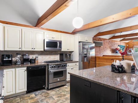 A kitchen at 125 Marcy Rd featuring: countertop, cabinetry, property, kitchen appliance, kitchen stove, home appliance, wood, kitchen, interior design, flooring