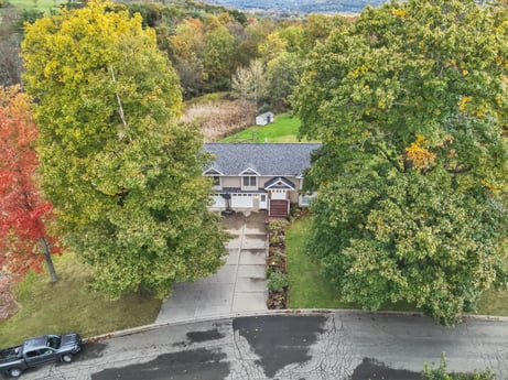 An image featuring property, building, plant, natural landscape, vegetation, neighbourhood, tree, road surface, house, biome at 74 Susquehannock Trail.