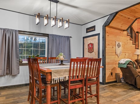 An image featuring table, furniture, property, wood, chair, interior design, curtain, window, flooring, wood stain at 17899 US-6.