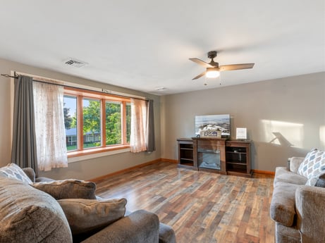 An image featuring couch, furniture, picture frame, window, ceiling fan, wood, interior design, beam, window blind, floor at 491 Hillcrest Dr.