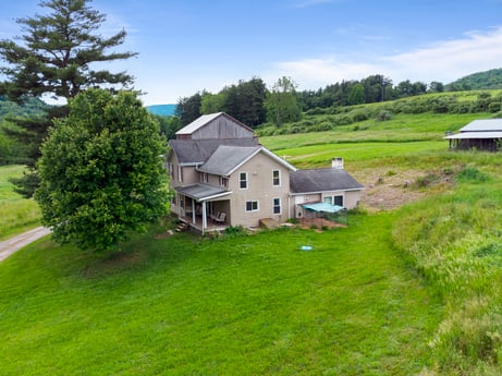 An image featuring cloud, plant, sky, building, nature, natural landscape, tree, house, highland, window at 709 Creek Rd.