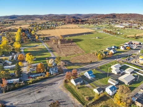 An image featuring sky, plant, building, land lot, mountain, urban design, tree, natural landscape, residential area, neighbourhood at Elm Dr.