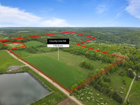 An image featuring cloud, sky, ecoregion, natural landscape, air travel, slope, land lot, highland, urban design, grassland at County Line Rd.