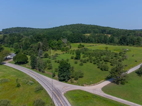 An image featuring sky, mountain, plant, tree, road surface, natural landscape, asphalt, land lot, slope, thoroughfare at 17899 US-6.