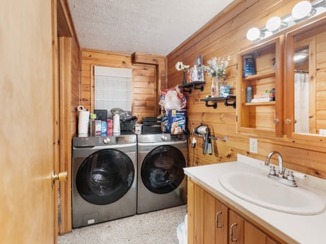 An image featuring brown, laundry room, tap, cabinetry, sink, property, kitchen sink, plumbing fixture, countertop, clothes dryer at 125 Marcy Rd.