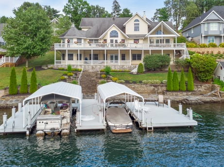 An image featuring water, boat, plant, building, window, watercraft, vehicle, sky, tree, house at 218 Point Rd.