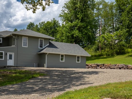 An image featuring plant, building, cloud, sky, window, house, tree, land lot, grass, siding at 17899 US-6.