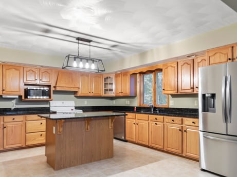 A kitchen at 74 Susquehannock Trail featuring: countertop, cabinetry, property, building, kitchen, drawer, kitchen appliance, kitchen stove, wood, interior design