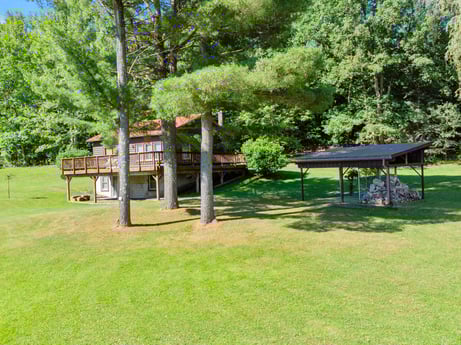 An image featuring plant, property, shade, tree, land lot, table, natural landscape, leisure, woody plant, grass at 735 Midnight Ln.