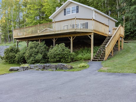 An image featuring plant, building, tree, house, shade, wood, siding, cottage, grass, porch at 127 Shore Dr.