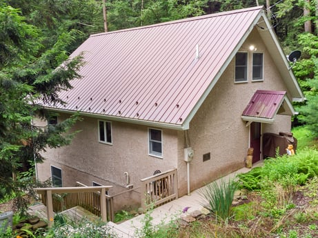 An image featuring plant, building, window, tree, wood, house, cottage, land lot, roof, fixture at 459 Pine Hill Dr.