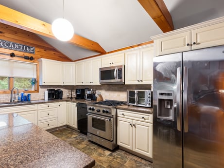 A kitchen at 125 Marcy Rd featuring: countertop, cabinetry, property, furniture, kitchen stove, kitchen appliance, kitchen, home appliance, wood, interior design