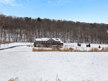 An image featuring sky, snow, plant, cloud, natural landscape, tree, building, house, freezing, landscape at Idle Wheels Ln.
