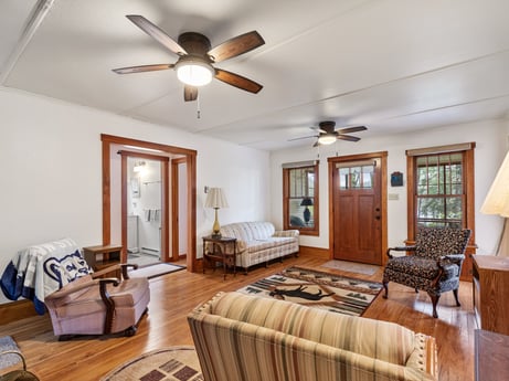 An image featuring picture frame, property, furniture, ceiling fan, wood, interior design, lighting, comfort, wood stain, floor at 103 Mokoma Ave.