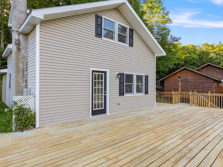 An image featuring building, window, cloud, sky, house, wood, tree, fixture, cottage, plant at 127 Shore Dr.