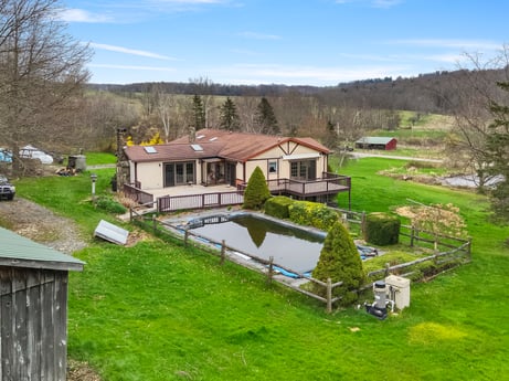 An image featuring cloud, plant, sky, property, water, building, tree, natural landscape, land lot, house at 1569 S Macafee Rd.