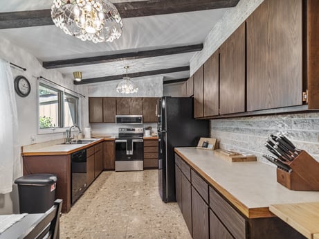 A kitchen at 104 Stony Mountain Rd featuring: cabinetry, furniture, countertop, kitchen stove, sink, kitchen appliance, kitchen, wood, lighting, architecture