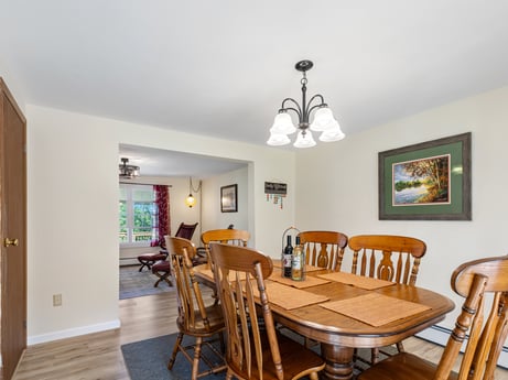 An image featuring table, chair, picture frame, wood, floor, flooring, laminate flooring, hardwood, real estate, living room at 62 Leons Rd.
