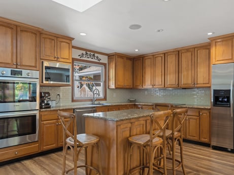 A kitchen at 125 Rimstone Ct featuring: countertop, cabinetry, furniture, property, wood, kitchen appliance, kitchen, interior design, home appliance, table