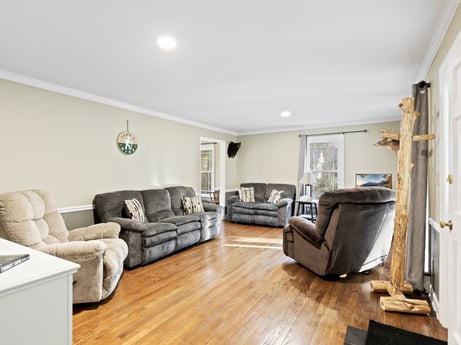 An image featuring couch, property, building, furniture, wood, interior design, floor, grey, flooring, laminate flooring at 1061 Muncy St.