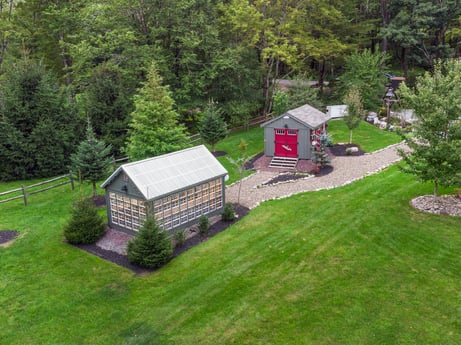 An image featuring plant, property, building, tree, natural landscape, land lot, cottage, landscape, wood, house at 276 Mountain View Ln.