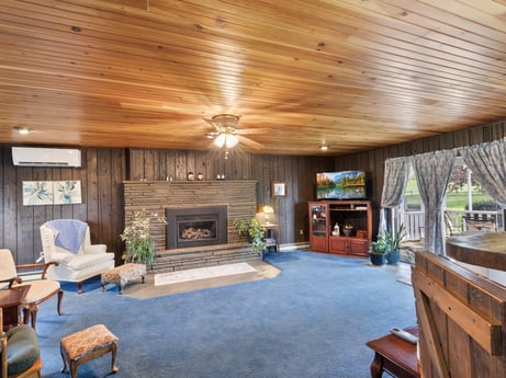An image featuring furniture, chair, wood, interior design, living room, floor, flooring, building, hardwood, ceiling at 1195 Twin Cuts Rd.