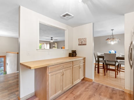 A kitchen at 491 Hillcrest Dr featuring: cabinetry, furniture, countertop, wood, interior design, flooring, grey, drawer, kitchen, floor