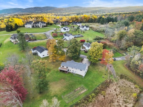 An image featuring plant, property, sky, plant community, ecoregion, natural landscape, leaf, building, cloud, land lot at 74 Susquehannock Trail.