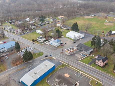 An image featuring property, building, infrastructure, bus, plant, asphalt, vehicle, house, tree, neighbourhood at 199 State St.