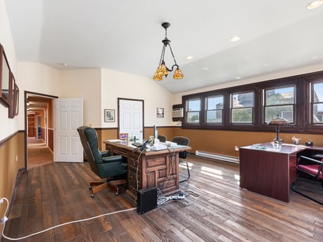 An image featuring table, furniture, window, picture frame, wood, architecture, living room, flooring, hall, floor at 213 Main St.